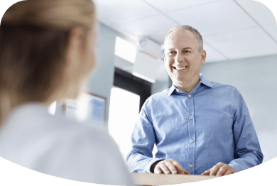 man talking with dental team member