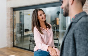 woman shaking the hand of a man